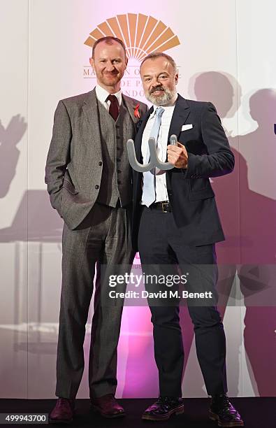 Mark Gatiss and Graham Norton, winner of the Winq Man Of The Year award, pose onstage at the Winq Magazine Men of the Year lunch to benefit the Elton...