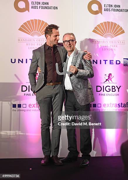 Jeremy Sheffield and Simon Carter, winner of the Winq Style Award, pose onstage at the Winq Magazine Men of the Year lunch to benefit the Elton John...
