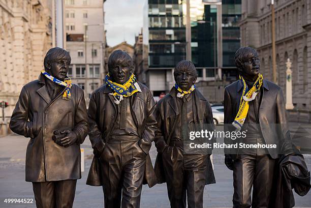 Cadiz football club scaves placed on a new statue of The Beatles by sculptor Andy Edwards is unveiled at Pier Head on December 4, 2015 in Liverpool,...