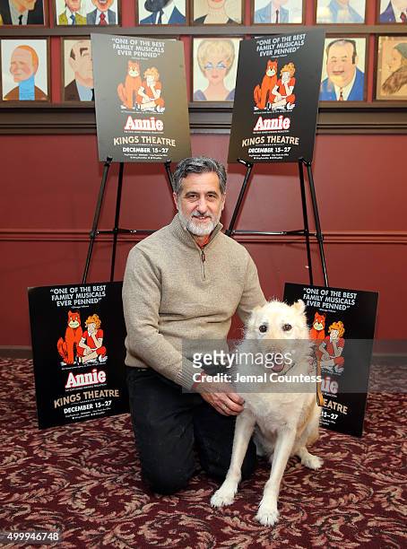 Animal trainer William Berloni and Mikey pose for a photo at the "Annie" Cast Phototcall at Sardi's on December 4, 2015 in New York City.