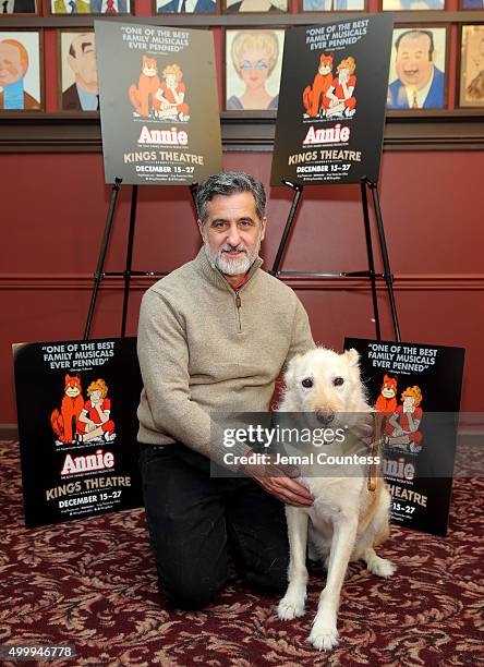 Animal trainer William Berloni and Mikey pose for a photo at the "Annie" Cast Phototcall at Sardi's on December 4, 2015 in New York City.