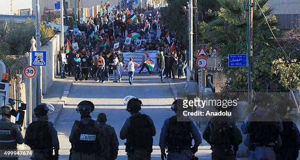 Israeli security forces are seen as a group of Palestinians gathered at Jabal Mukaber neighborhood stage a protest in Jerusalem on December 4, 2015...