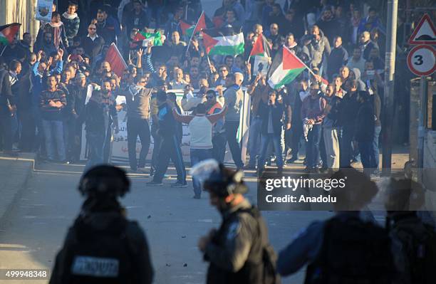 Group of Palestinians gathered at Jabal Mukaber neighborhood stage a protest in Jerusalem on December 4, 2015 after Israel didn't give the bodies of...