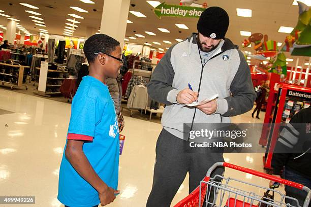 Nikola Pekovic of the Minnesota Timberwolves goes shopping for holiday gifts with kids who are up for adoption through the Minnesota Timberwolves...