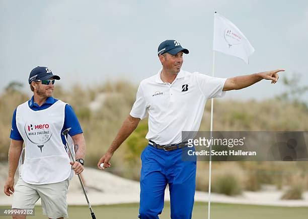 Matt Kuchar of the United States walks off the first green with his caddie John Wood during the second round of the Hero World Challenge at Albany,...