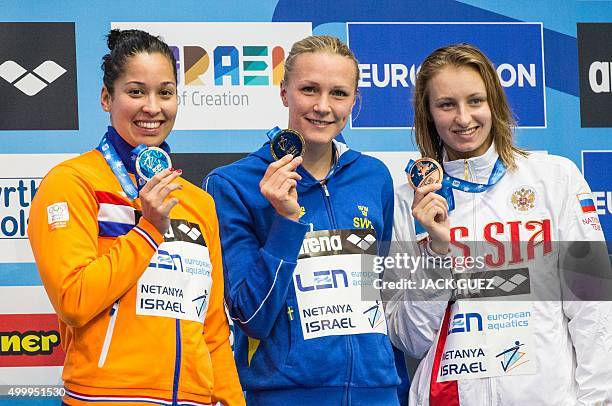 Sweden's gold medalist Sarah Sjostrom , Dutch silver medalist Ranomi Kromowidjojo and Russian bronze medalist Veronika Popova stand on the podium...