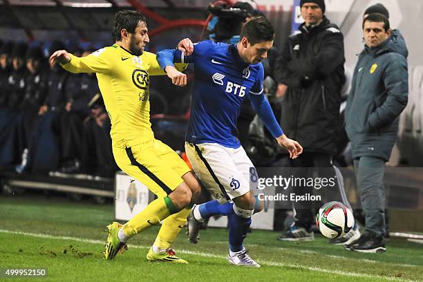 Aleksandr Tashayev of FC Dynamo Moscow challenged by Kamil Agalarov of FC Anji Makhachkala during the Russian Premier League match between FC Dynamo...