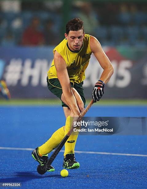 Simon Orchard of Australia runs with the ball during the match between Australia and Netherlands on day eight of The Hero Hockey League World Final...