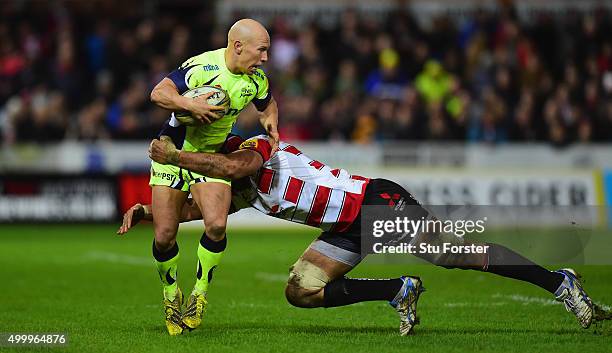 Peter Stringer of Sale is tackled by Gloucester number 8 Sione Kalamafoni during the Aviva Premiership match between Gloucester Rugby and Sale Sharks...