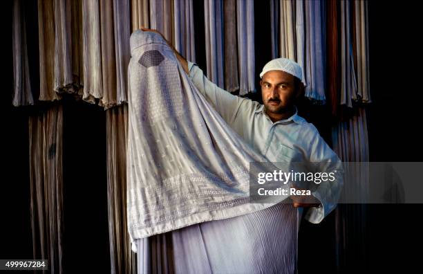 Mazar-e Sharif, Afghanistan. A burqa vendor in the city of Mazar-e-Sharif.