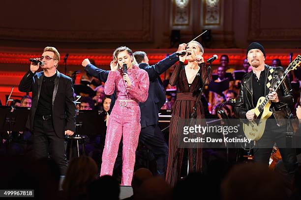 Musicians Bono, Miley Cyrus and Jessie J perform on stage during the ONE Campaign and s concert to mark World AIDS Day, celebrate the incredible...