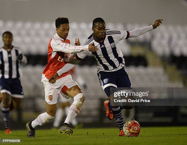 Chris Willock of Arsenal challenges Jonathan Leko of WBA during the match between Arsenal U18 and West Bromwich Albion U18 in the FA Youth Cup at...