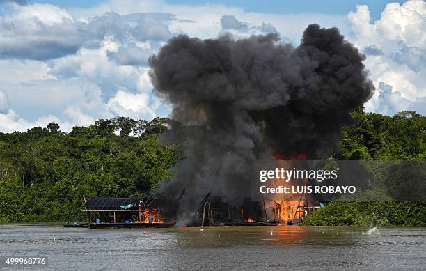 Explosives detonate at an illegal gold mine during the Anostomus II operation against illegal mining by the Inirida River in the Puinawai National...