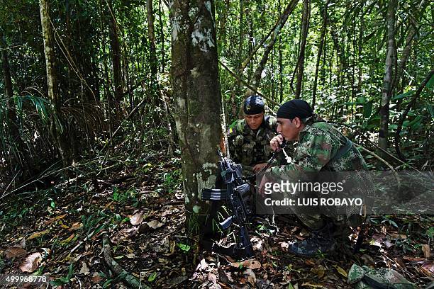 Colombian soldiers use a communications radio during the Anostomus II operation against illegal mining by the Inirida River in the Puinawai National...