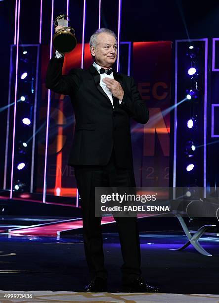 American actor and comedian Bill Murray holds his award as he receives a career tribute during the opening ceremony of the 15th edition of the...