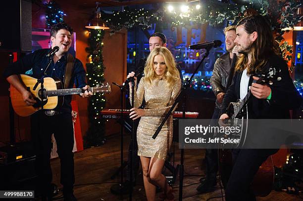 Kylie Minogue with Marcus Mumford, Ted Dwane and Winston Marshall from Mumford and Sons perform during a live broadcast of "TFI Friday" on December...