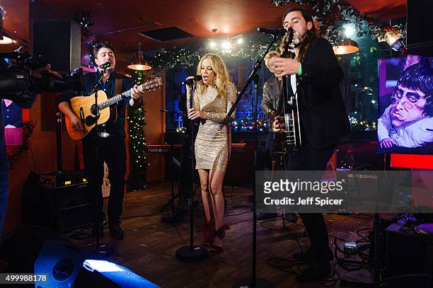 Kylie Minogue with Marcus Mumford, Ted Dwane and Winston Marshall from Mumford and Sons perform during a live broadcast of "TFI Friday" on December...