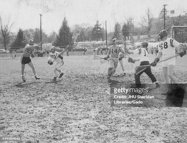Lacrosse, Alfred Lester Seivold, Edward Bernstein, Game against University of Virginia in progress, Seivold firing goal as Bernstein looks on, 1959. .