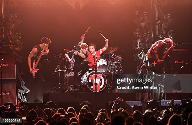 Musicians Calum Hood, Luke Hemmings, Ashton Irwin and Michael Clifford of 5 Seconds Of Summer perform onstage during 102.7 KIIS FMs Jingle Ball 2015...