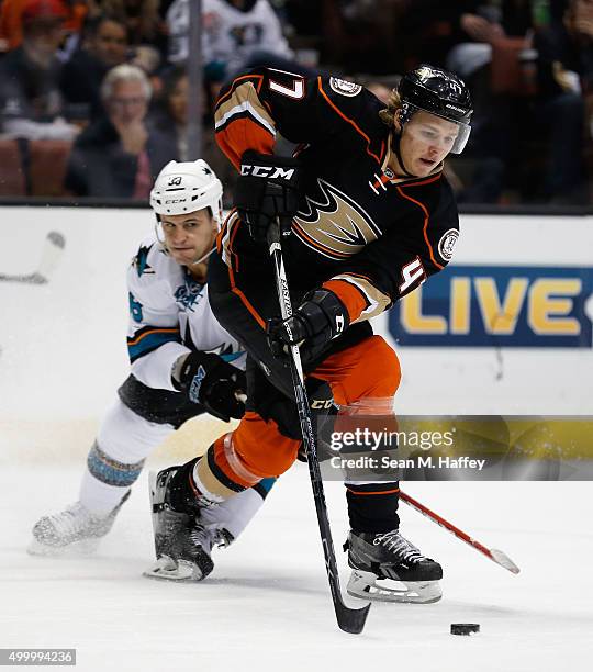 Hampus Lindholm of the Anaheim Ducks battles with Micheal Haley of the San Jose Sharks during the second period at Honda Center on December 4, 2015...