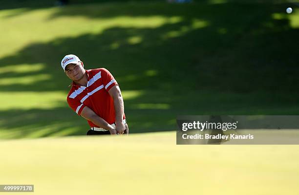 Zander Lombard of South Africa plays a shot onto the 18th green during day three of the 2015 Australian PGA Championship at Royal Pines Resort on...