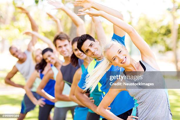 fit woman with friends exercising at park - military camp stock pictures, royalty-free photos & images