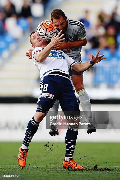 Andrew Durante of the Wellington Phoenix competes for the ball with Besart Berisha of the Melbourne Victory during the round nine A-League match...