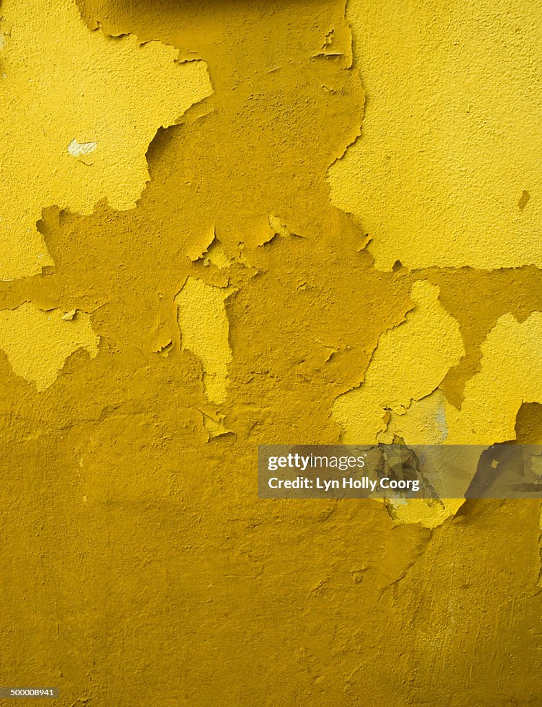 Old yellow wall with peeling paint