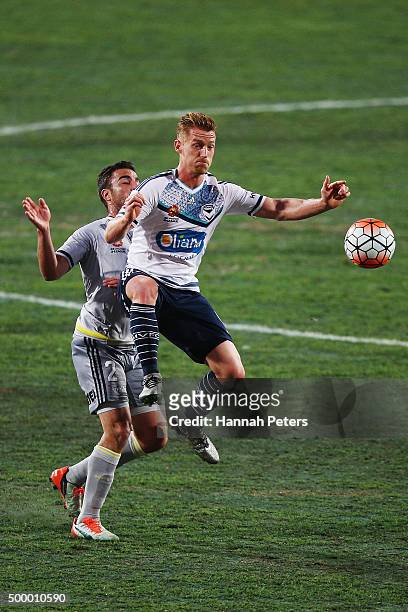 Emmanuel Muscat of the Wellington Phoenix competes for the ball with Oliver Bozanic of the Melbourne Victory during the round nine A-League match...