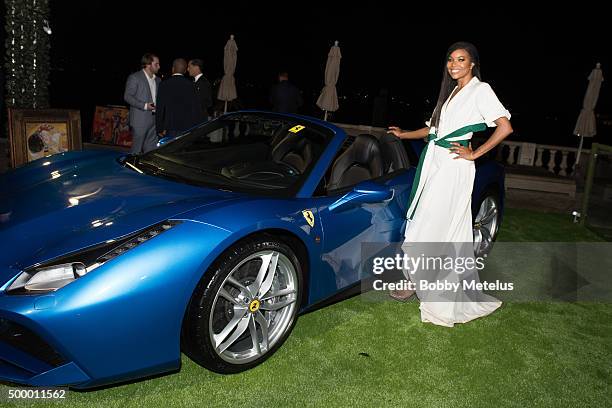 Gabrielle Union strikes a pose with the new Ferrari F88 Spider during the Hublot & Haute Living Toast Art Basel with Private Dinner hosted by Dwyane...