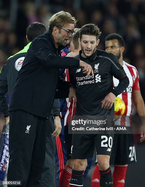 Jurgen Klopp manager of Liverpool talks to Adam Lallana of Liverpool during the Capital One Cup Quarter Final between Southampton and Liverpool at St...