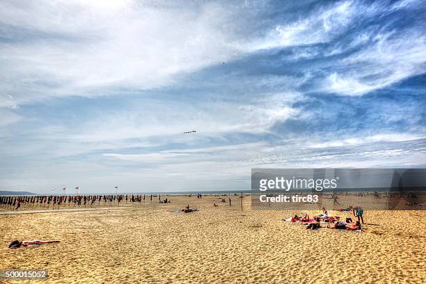 several people on beach at deauville - deauville beach stock pictures, royalty-free photos & images