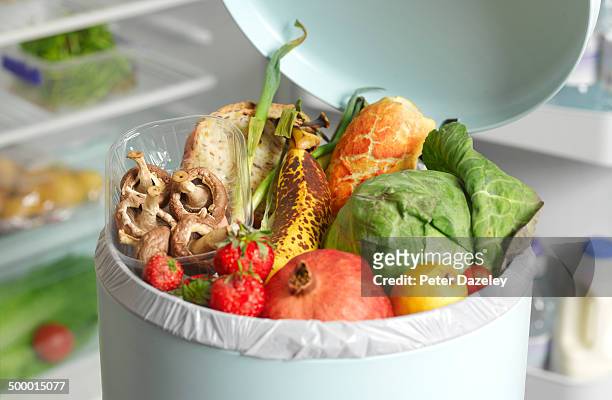 out of date rotting food in dustbin - comida básica fotografías e imágenes de stock
