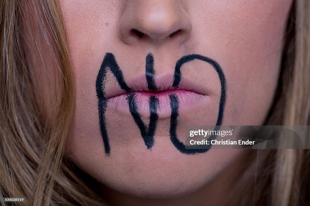 Woman with writing "No" on her lips