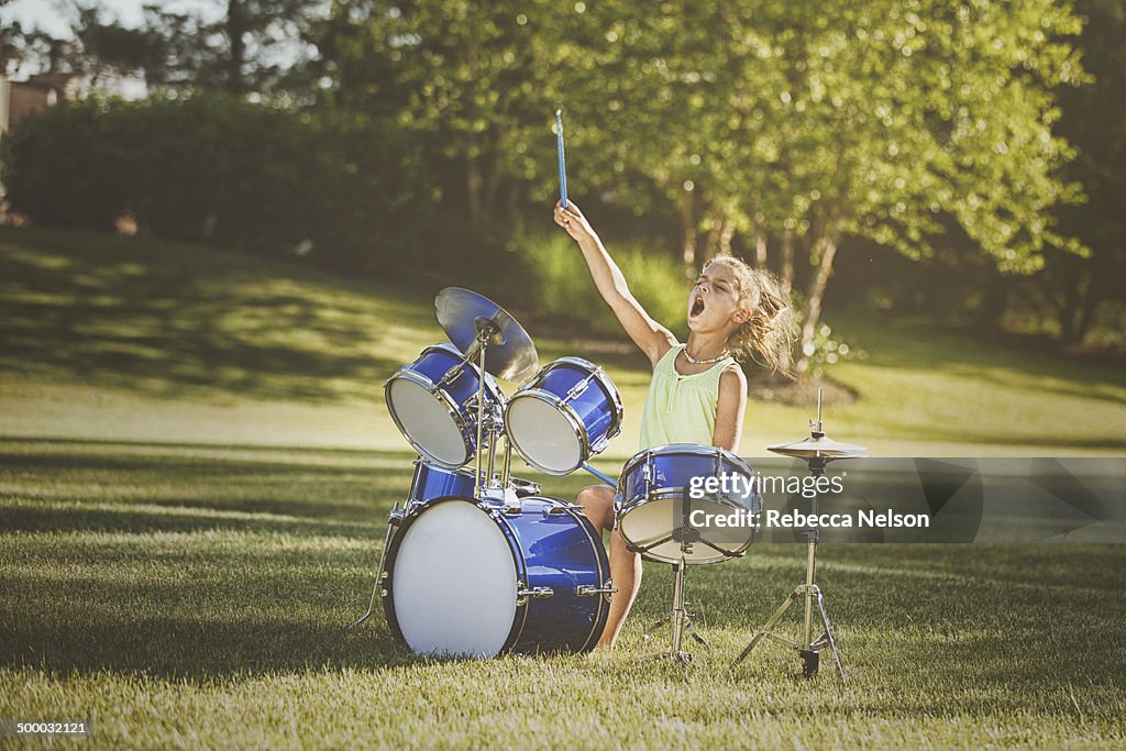 Girl drumming with wild abandon