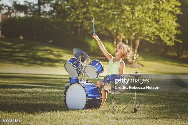 girl drumming with wild abandon - drum kit stock pictures, royalty-free photos & images