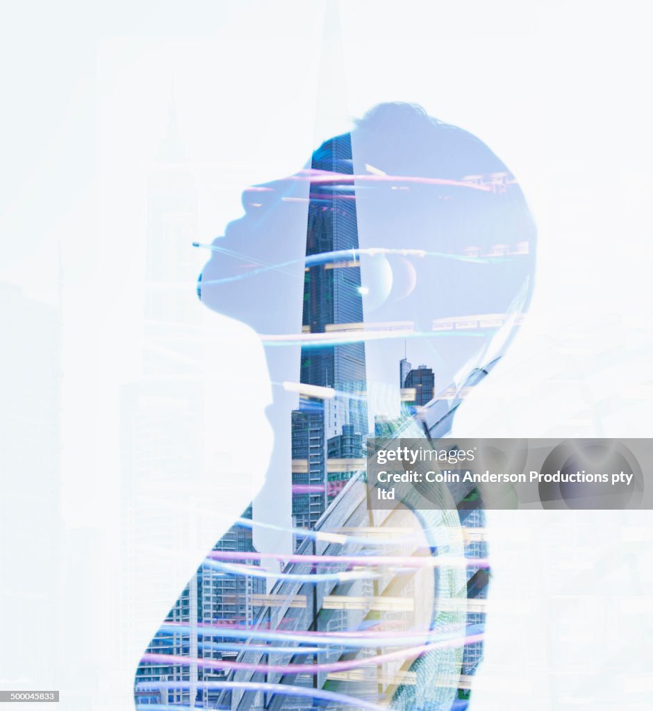 Woman's silhouette in reflection of city skyscrapers