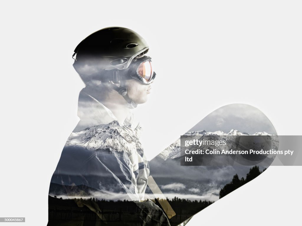 Snowboarder's silhouette in reflection of snowy mountains