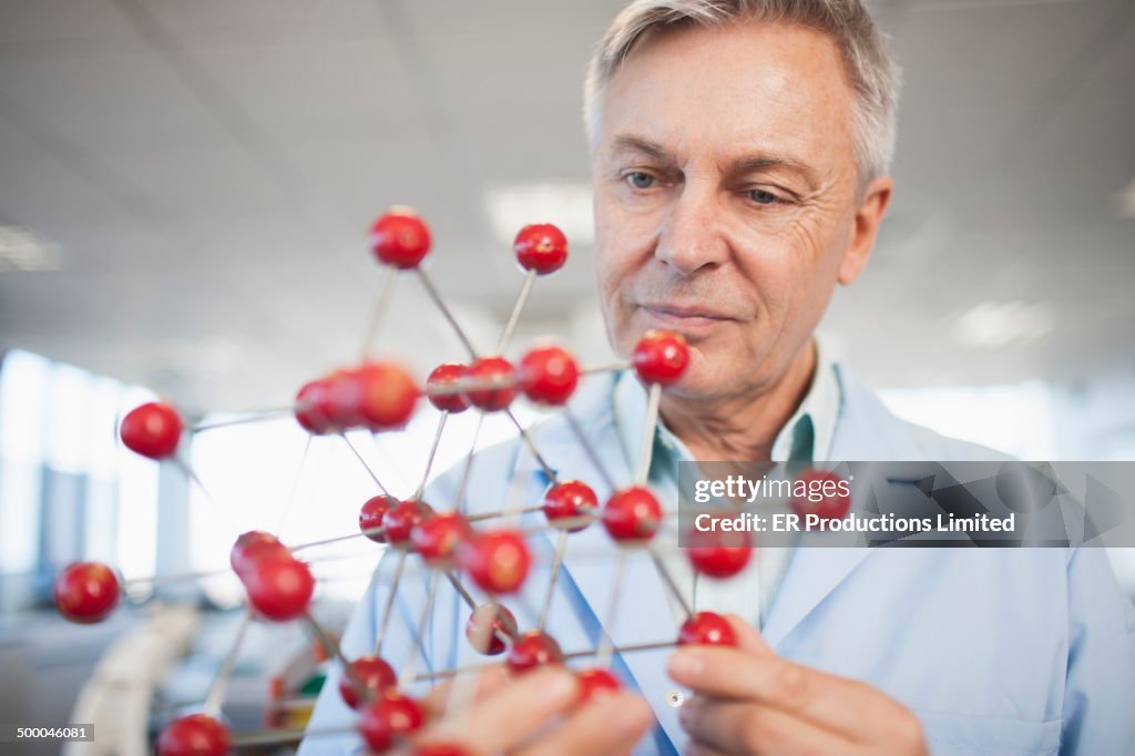 Caucasian scientist examining molecular model