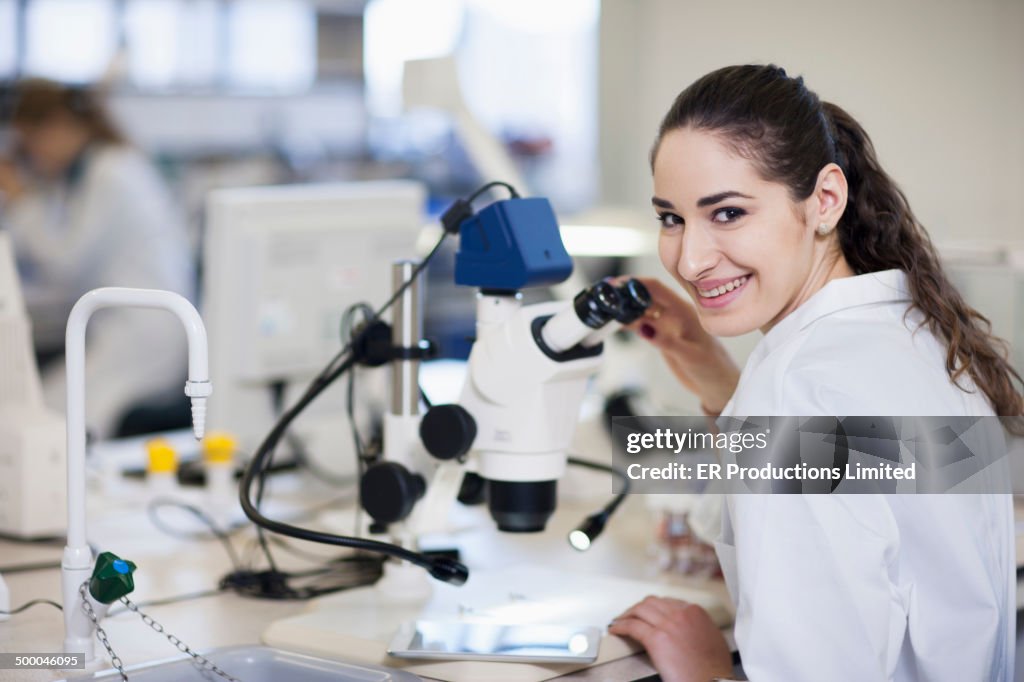 Student using microscope in lab