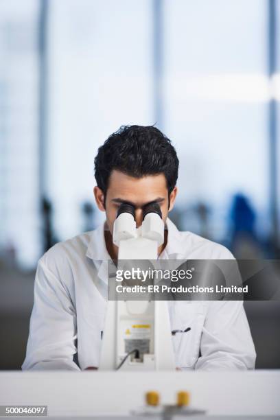 indian scientist using microscope in lab - microscope stock pictures, royalty-free photos & images