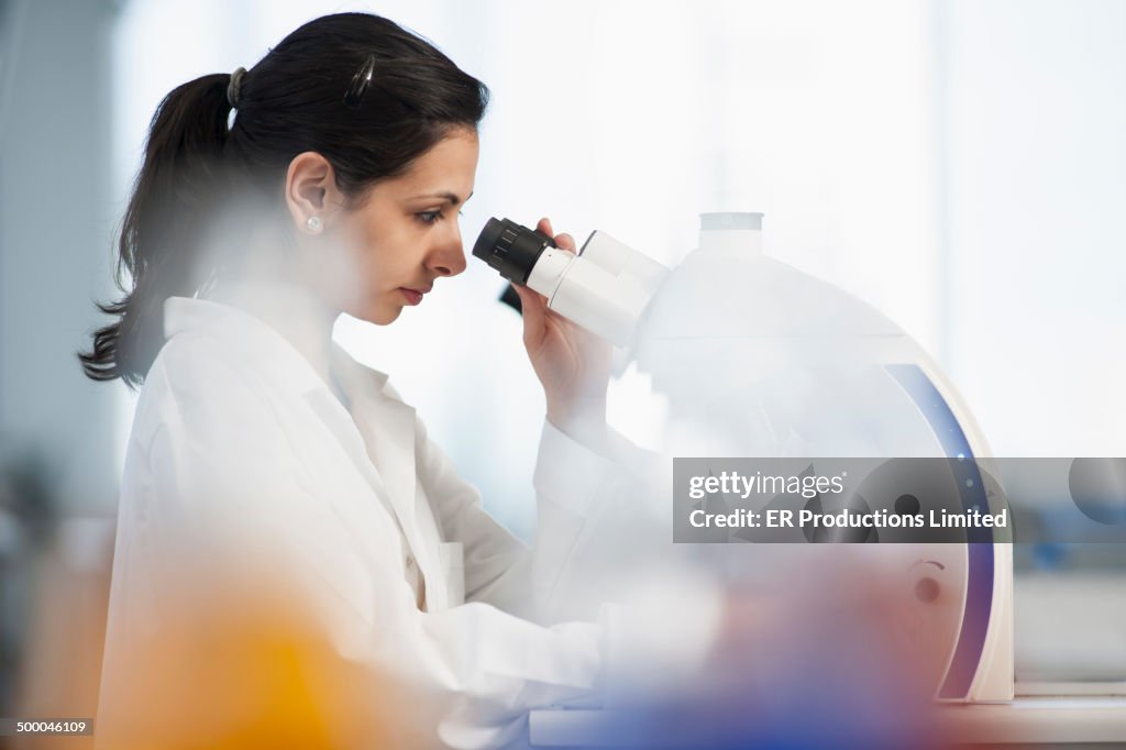 Pakistani scientist using microscope in lab