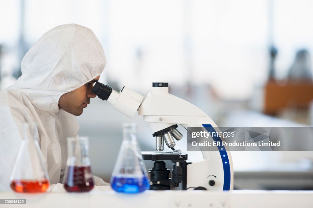 Indian scientist using microscope in lab