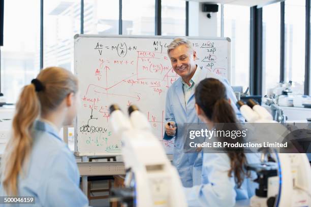 teacher talking to students in lab - science lab school stock-fotos und bilder