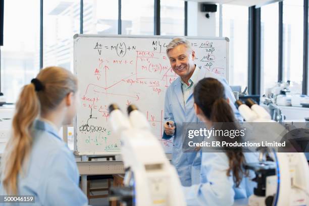 teacher talking to students in lab - mathematician ストックフォトと画像