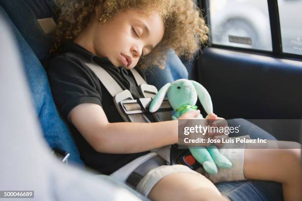 mixed race boy sleeping in car seat - stuffed toy stock pictures, royalty-free photos & images