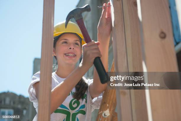 caucasian volunteer building house - only girls stock pictures, royalty-free photos & images