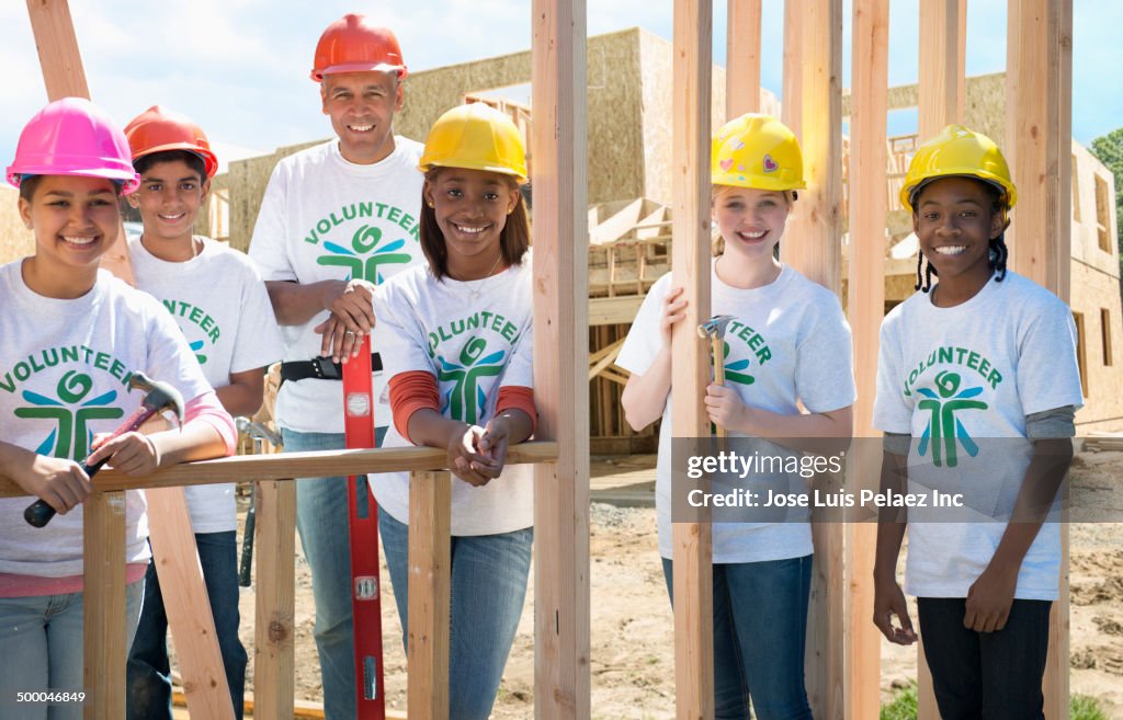 Volunteers building house together