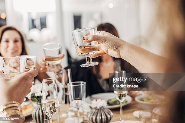 mature women having dinner party - new year's eve dinner stock pictures, royalty-free photos & images