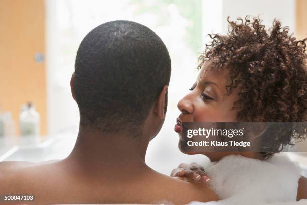 african american couple relaxing in bath - couple and kiss and bathroom 個照片及圖片檔